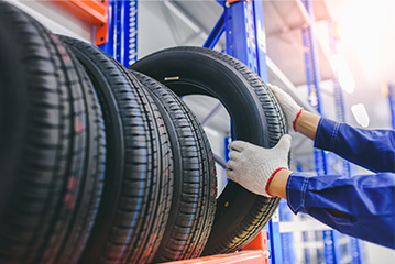 Person hands grabbing a car tire